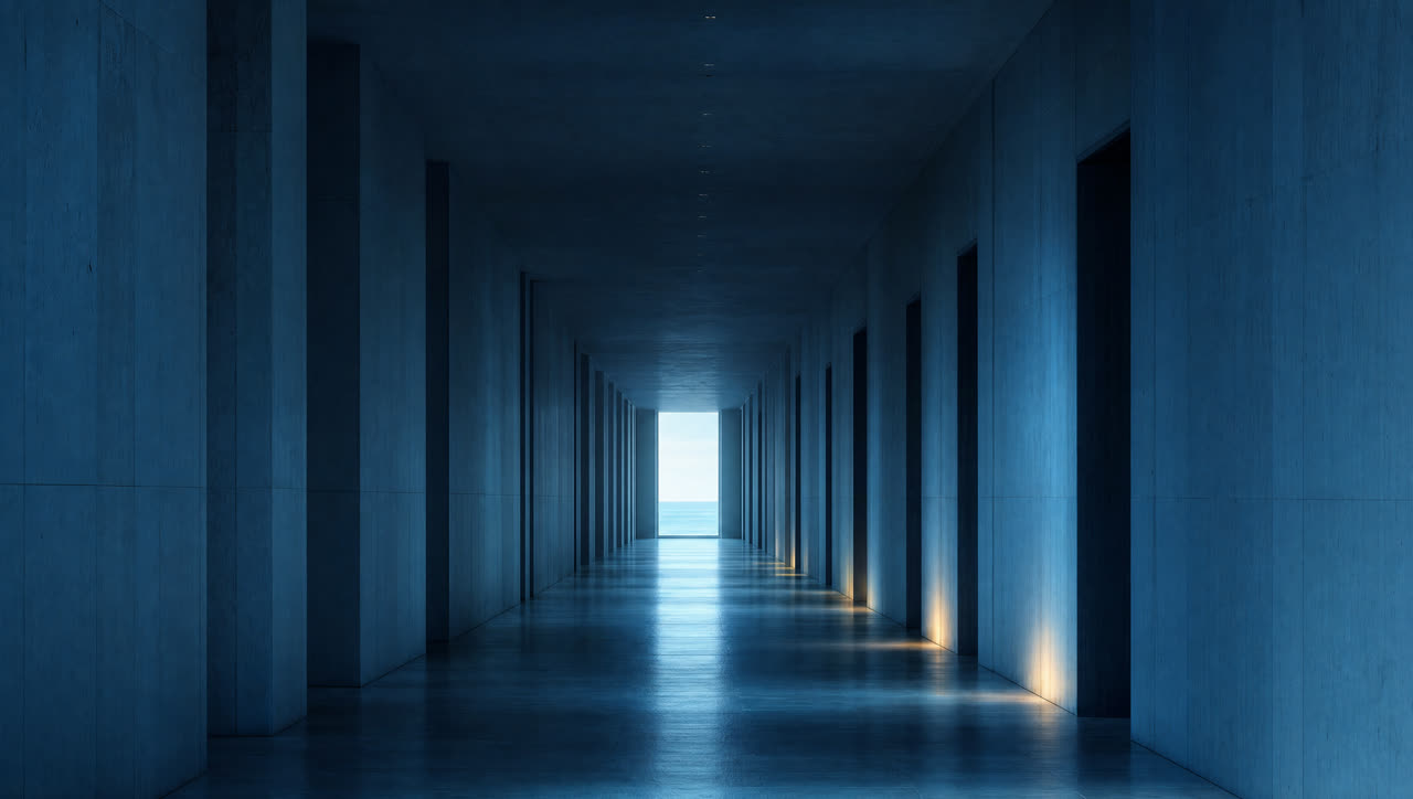 A long shadowed corridor leading to daylight
